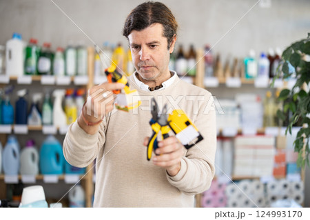 man holding repair tools in his hands man holding repair tools in his hands 124993170