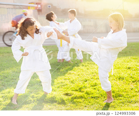 Kids in pairs sparring together Kids in pairs sparring together 124993306