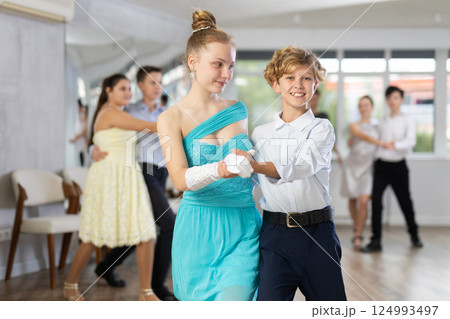 Boy and girl dancing waltz in studio 124993497