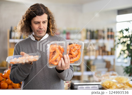 Man choose frozen shrimp for homemade lunch at supermarket Man choose frozen shrimp for homemade lunch at supermarket 124993536