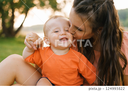 Mother Kissing Baby During Picnic Mother Kissing Baby During Picnic 124993822