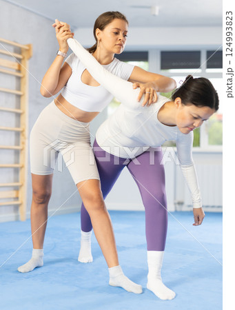 Two young women training self-defense techniques 124993823
