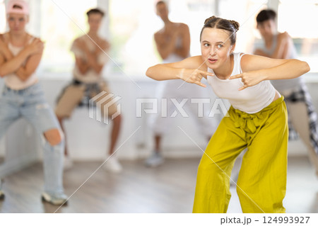 Group of girls an boys perform choreographic exercises and teaches energetic breakdancing waacking together Group of girls an boys perform choreographic exercises and teaches energetic breakdancing waacking together 124993927