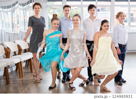 Smiling teenagers with female teacher bowing after dance performance 124993931