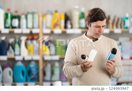 Man choosing deodorants in supermarket 124993947