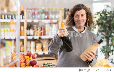 Adult man chooses wine or champagne 124994003