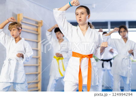 Group of children train karate techniques 124994294