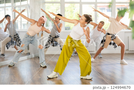 Teenage girl practicing hip-hop dance in training hall 124994670