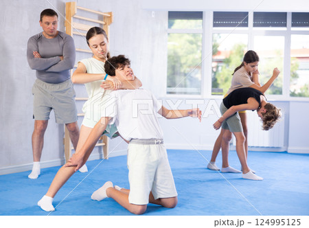 Boy and girl practicing self-defense techniques Boy and girl practicing self-defense techniques 124995125