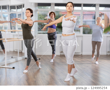 Group of female beginners rehearsing ballet dance 124995254