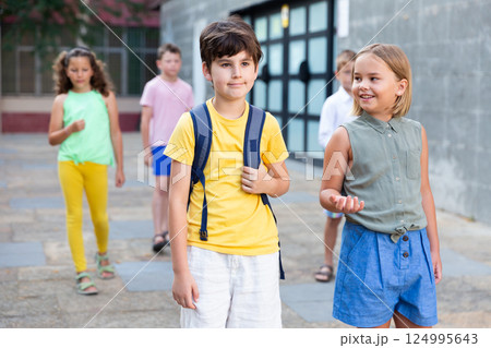 Young girl and boy walking together 124995643