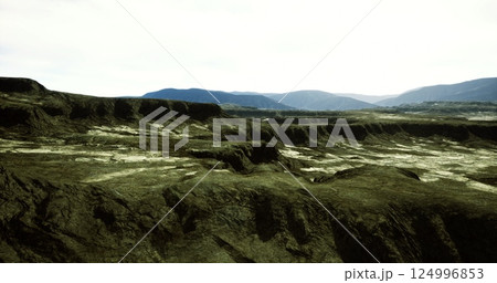 Landscape features rugged terrain under a bright sky in a remote area 124996853