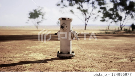 Hydrant standing alone in a dry landscape under a clear sky Hydrant standing alone in a dry landscape under a clear sky 124996977