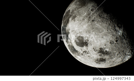 sunlit crescent of the moon visible from a distance in space 124997343