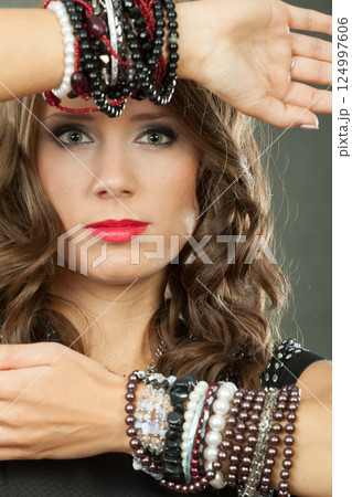 Elegant woman wearing multiple bracelets Elegant woman wearing multiple bracelets 124997606