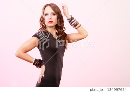 woman with jewellery in black evening dress 124997624