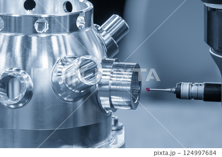 The multi axis CMM machine measuring the aluminum housing parts in the light blue scene. 124997684