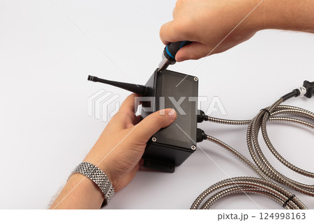 Hands of a master holding an electronic board on a Hands of a master holding an electronic board on a 124998163