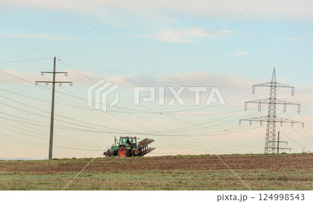 Tractor working the agricultural fields outside of Stuttgart city, Germany 124998543