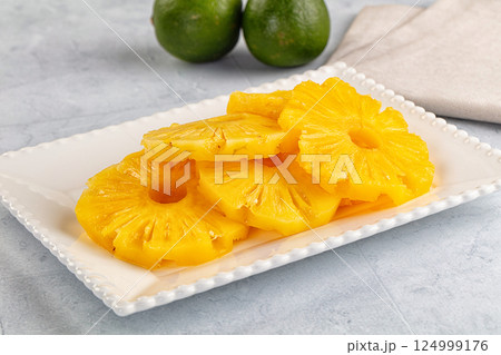 Sweet canned pineapple slices in syrope Sweet canned pineapple slices in syrope 124999176