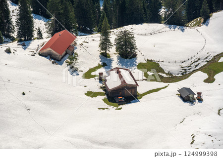 Cabin in the Bavarian Alps surrounded by snow, high angle view 124999398