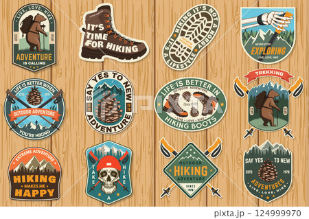 Set of hiking outdoor adventure emblems, logos, badges. Hiking related typographic quote. Design with human skeleton hand holding hiker pole, hiking boot, pine cone, mountains. 124999970