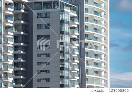 Modern apartment buildings in Limassol with glass balconies are enjoying a beautiful sunny day. Cyprus Modern apartment buildings in Limassol with glass balconies are enjoying a beautiful sunny day. Cyprus 125000866