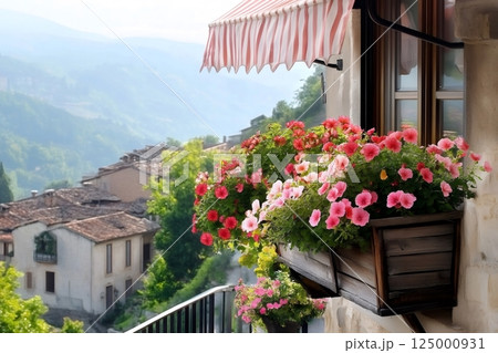 Blooming petunias decorating window box overlooking picturesque italian village 125000931