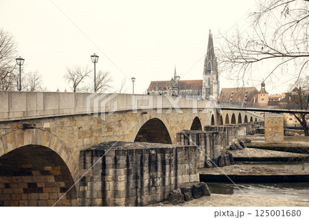 A scenic view of the old stone bridge crossing the Danube River in Regensburg, Germany, with the 125001680