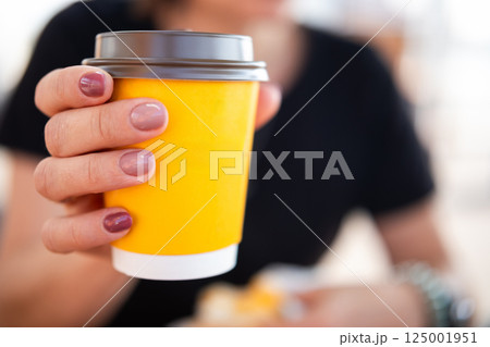 Girl Drinking Coffee From A Disposable Cup Girl Drinking Coffee From A Disposable Cup 125001951