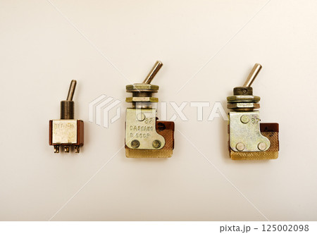 An electronic switch. Electric switch on a white background. An electronic switch. Electric switch on a white background. 125002098