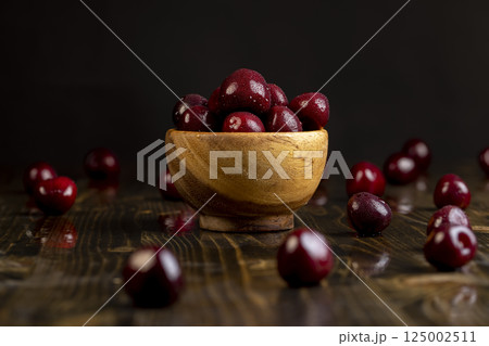 cherry in drops of water, wet cherry fruits on the kitchen table cherry in drops of water, wet cherry fruits on the kitchen table 125002511