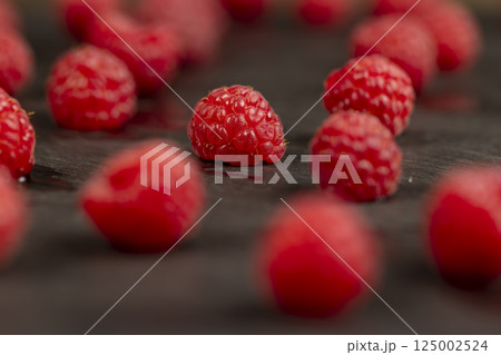 raspberries on the table, the collected amount of ripe raspberries is red close up raspberries on the table, the collected amount of ripe raspberries is red close up 125002524