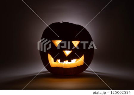 one halloween pumpkin backlit background 125002554