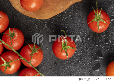 ripe small red tomatoes during cooking, several red round cherry tomatoes 125002572