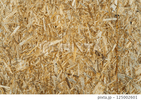 Abstract OSB texture for building materials and interior decor. Detailed oriented strand board surface texture for construction use. Natural wood background ideal for eco design and template creation 125002601