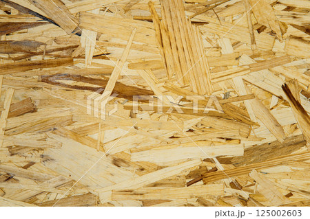 Abstract OSB texture for building materials and interior decor. Detailed oriented strand board surface texture for construction use. Natural wood background ideal for eco design and template creation 125002603