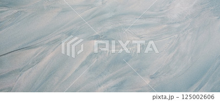 Wet sand texture background with natural wave pattern for template or design. Sand pattern background after wave flow for nature, travel and relaxation themes Banner 125002606