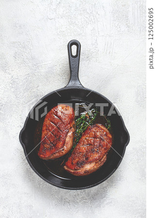 roast duck breast, in a frying pan, with spices and herbs, close-up, no people, roast duck breast, in a frying pan, with spices and herbs, close-up, no people, 125002695