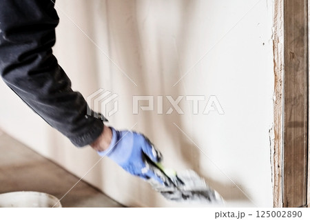 Sealing openings between drywall. Leveling the walls with a spatula. With space to copy. High quality photo 125002890