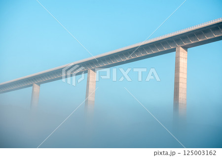 Autobahn bridge over dense fog, low angle view, in Braunsbach, Germany 125003162