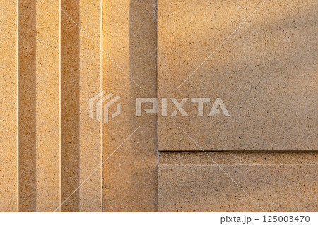 Textured concrete wall surface showcasing a geometric linear pattern Textured concrete wall surface showcasing a geometric linear pattern 125003470