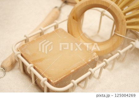 Natural soap and bamboo accessories on a soft surface 125004269