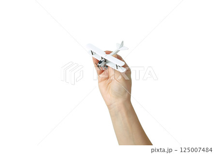 A hand holds a small white airplane, symbolizing vacation, isolated on white 125007484