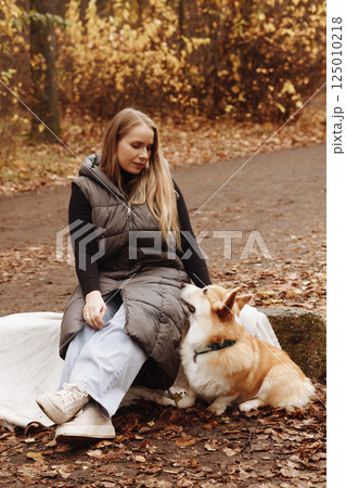 Woman with Corgi in Autumn Park 125010218