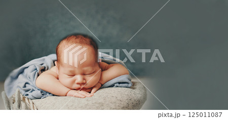 A newborn baby is wrapped in diapers with a wool cap in a basket. Swaddling, maternity hospital, family, ivf, life planning, parenting. A mother's love for her child. Baby food. High quality photo A newborn baby is wrapped in diapers with a wool cap in a basket. Swaddling, maternity hospital, family, ivf, life planning, parenting. A mother's love for her child. Baby food. High quality photo 125011087