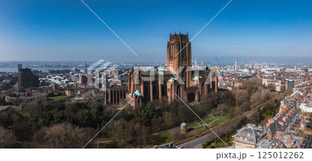 Aerial view of Liverpool featuring the Gothic Revival Liverpool Cathedral, green spaces, urban skyline, River Mersey, and Radio City Tower under a clear sky. 125012262