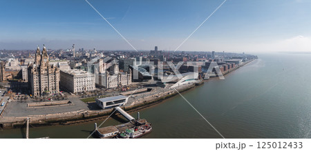 Aerial view of Liverpool showcasing the Royal Liver Building, Cunard Building, Port of Liverpool Building, Museum of Liverpool, and the Mersey River. Aerial view of Liverpool showcasing the Royal Liver Building, Cunard Building, Port of Liverpool Building, Museum of Liverpool, and the Mersey River. 125012433
