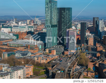 Aerial view of Manchester, UK, featuring Deansgate Square towers, the Manchester Central Convention Complex, railway tracks, and urban architecture. 125012528