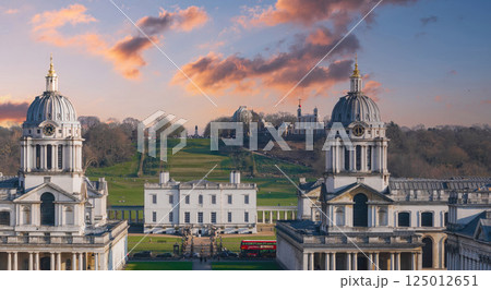 The Old Royal Naval College's twin domes, Queen's House, Greenwich Park hill, and Royal Observatory with a red bus in the foreground in London. 125012651